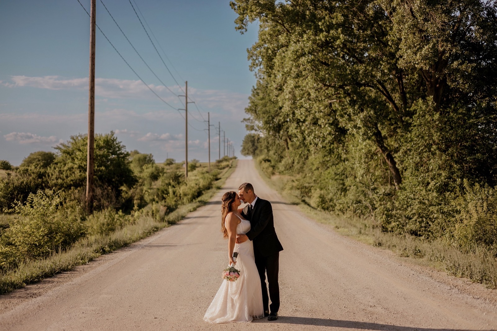 A newly married couple taking sunset portraits near Bella's Farmhouse