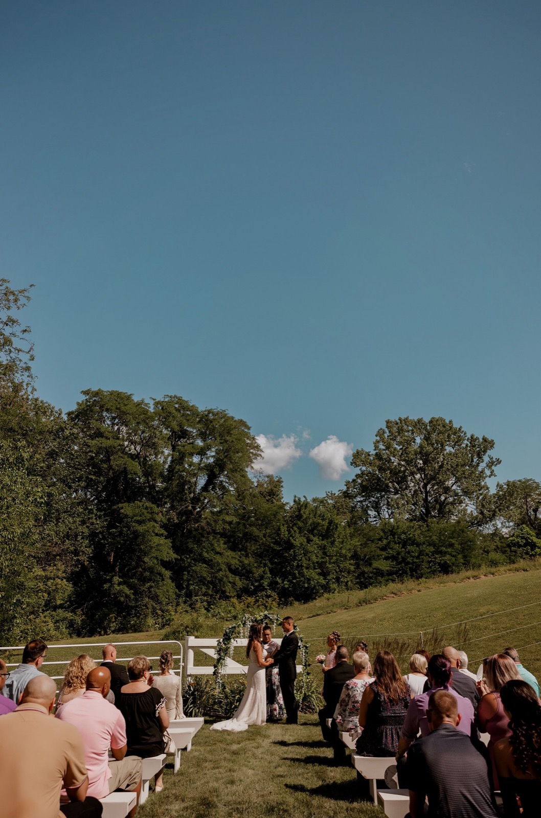 An outdoor wedding ceremony at Bella's Farmhouse