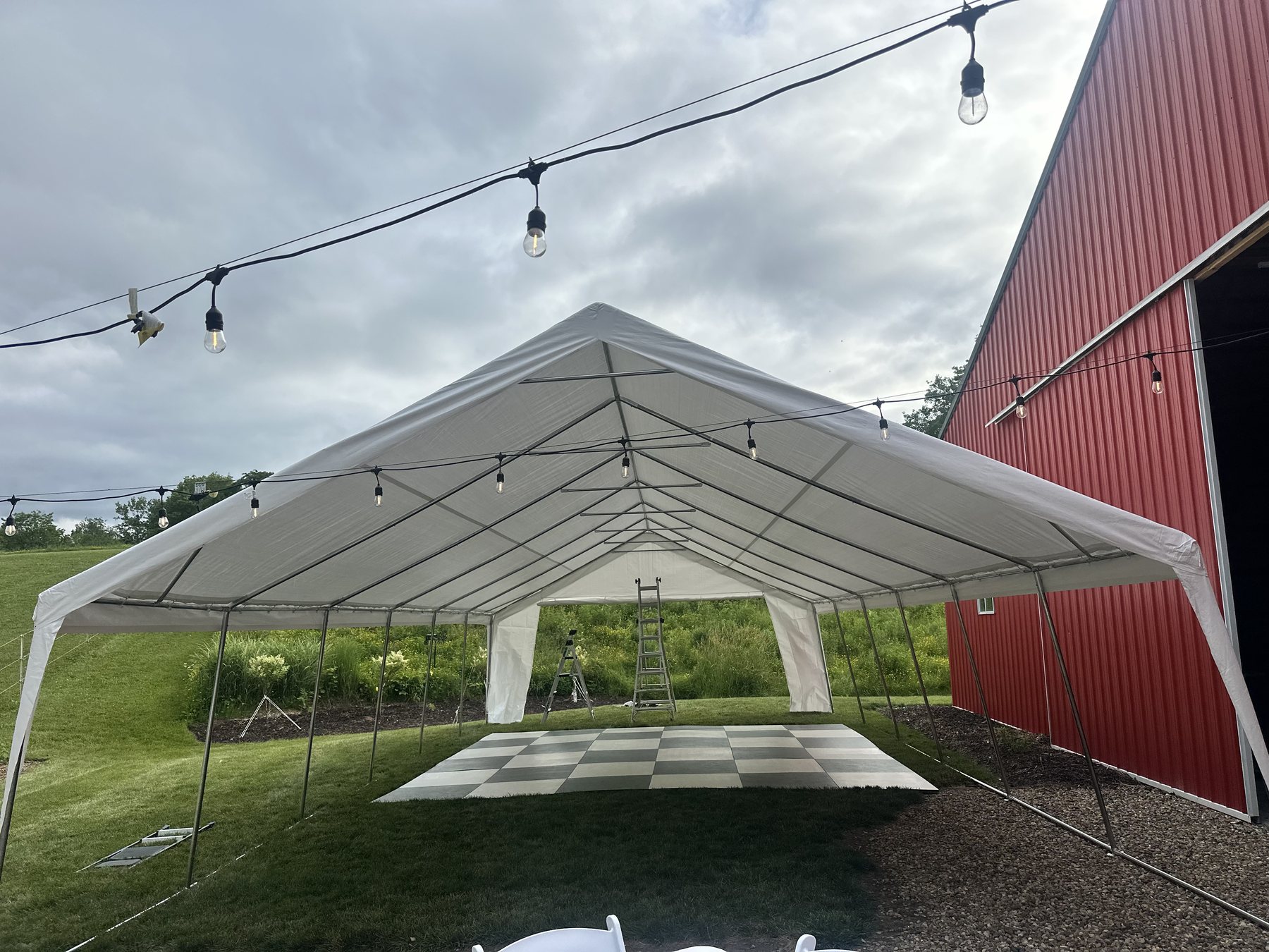 White event tent near the red barn at Bella's Farmhouse