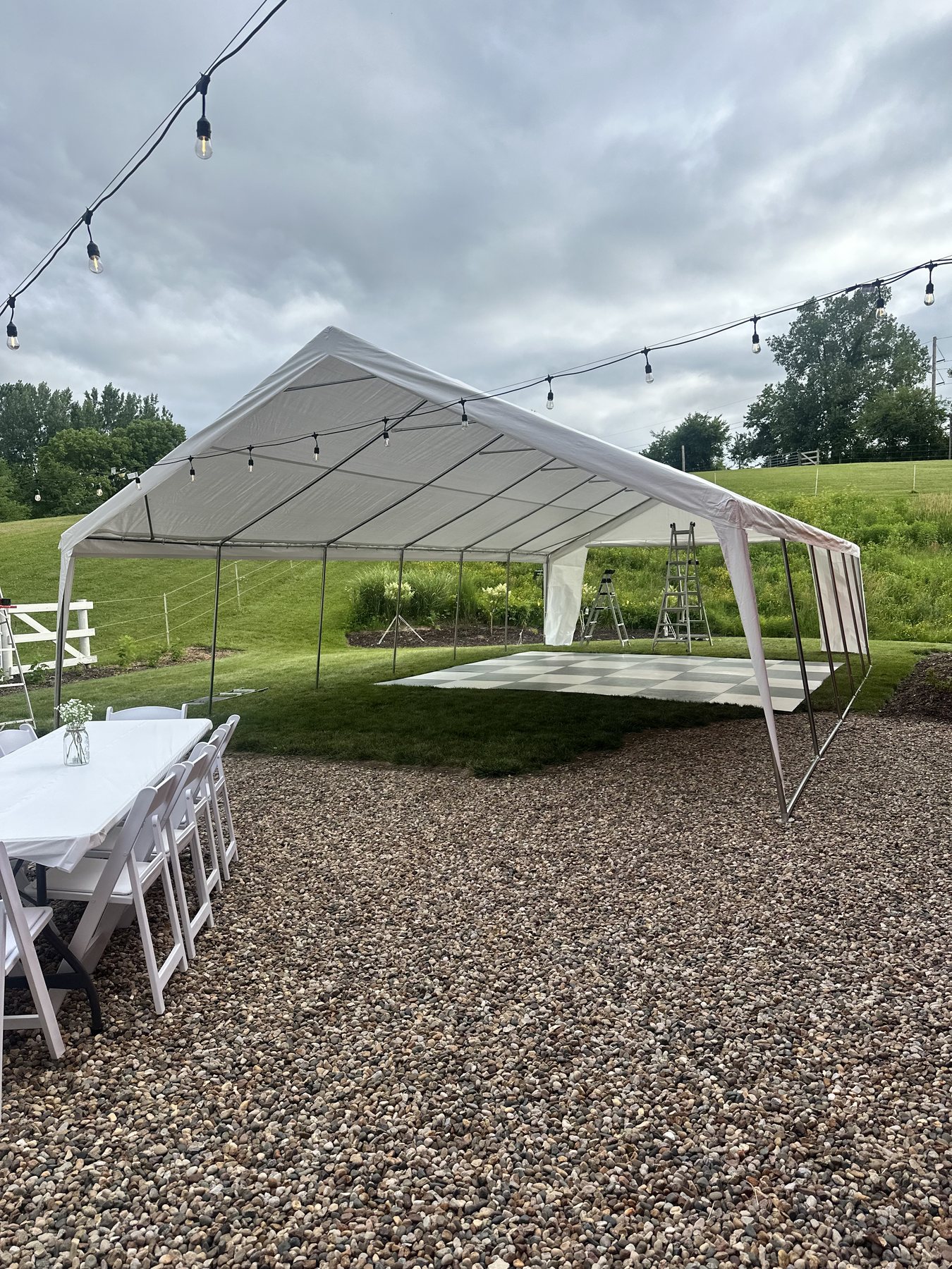 Tent rental set up with string lights and dance floor