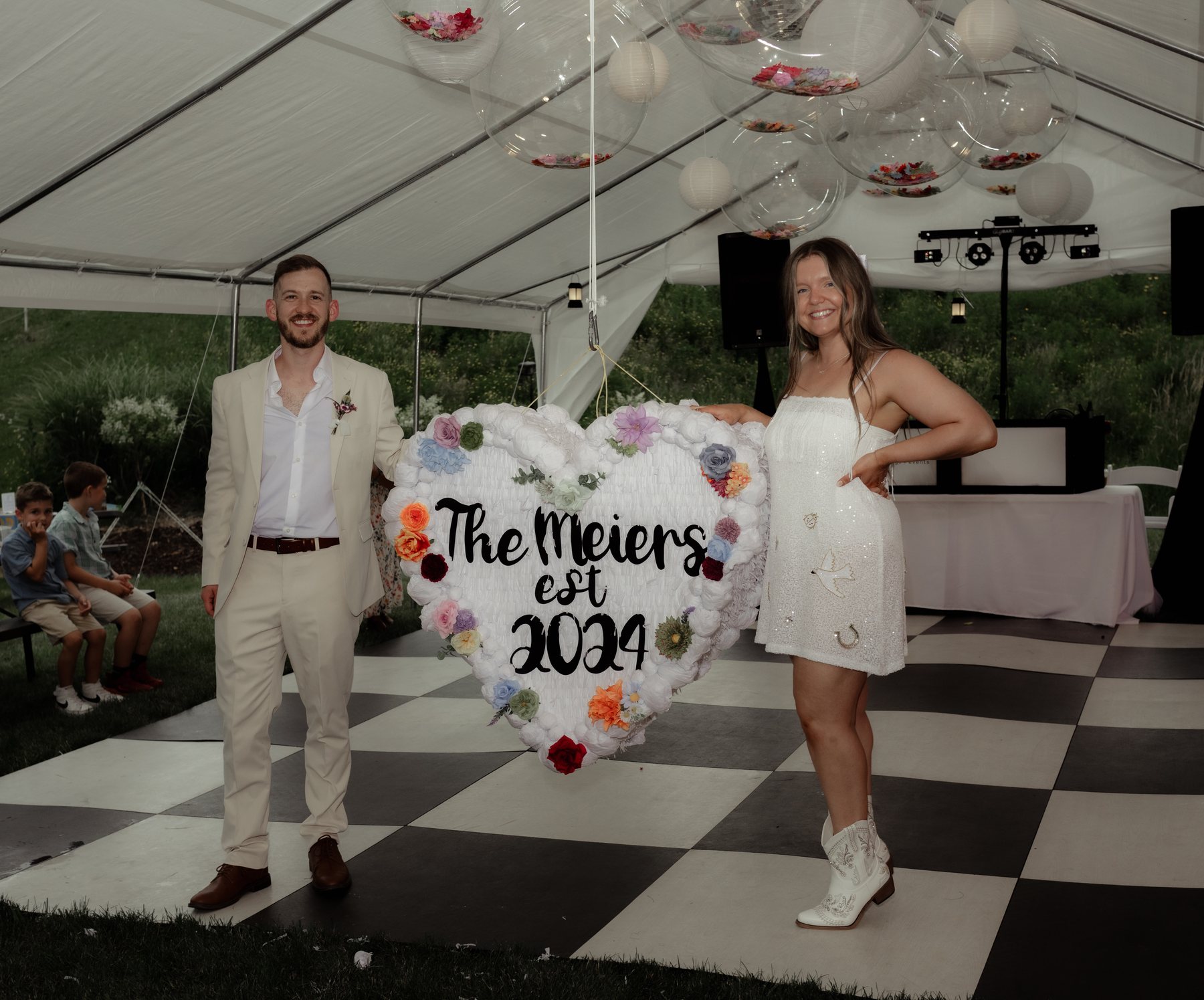 Couple posing under the tent at Bella's Farmhouse
