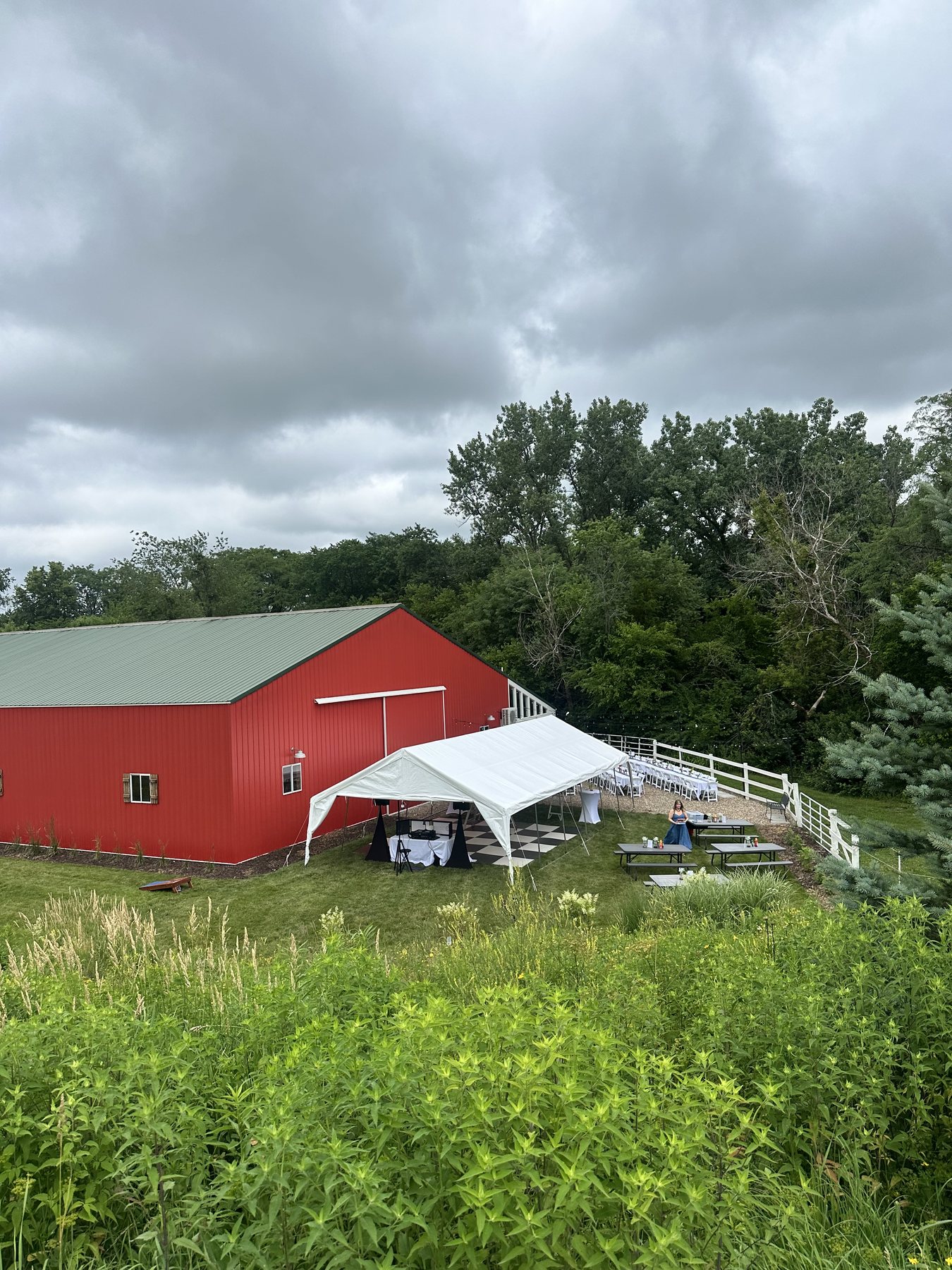 Outdoor tent setup viewed from the hillside